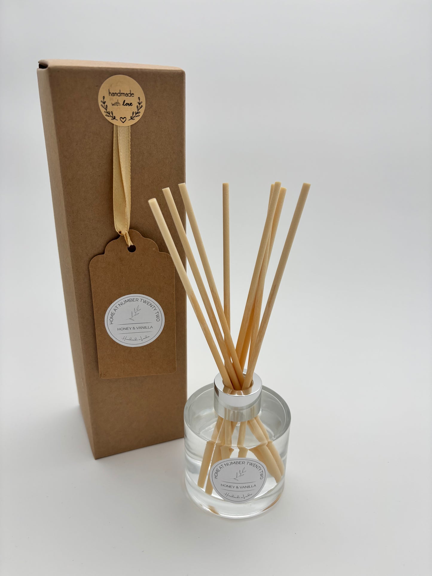 Honey and Vanilla Reed Diffuser in clear, glass bottle with silver cap, natural coloured rattan reeds and kraft Home at Number Twenty Two gift box