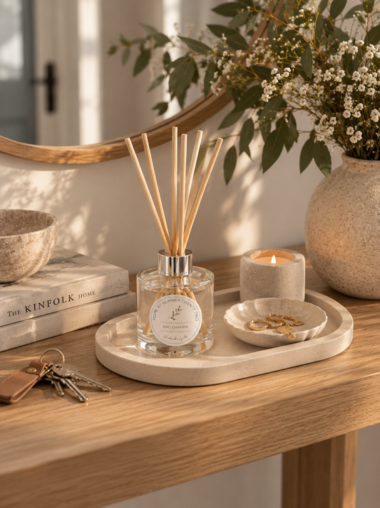 Cream Jesmonite trinket tray with reed diffuser and keys on a Scandi style hallway console table