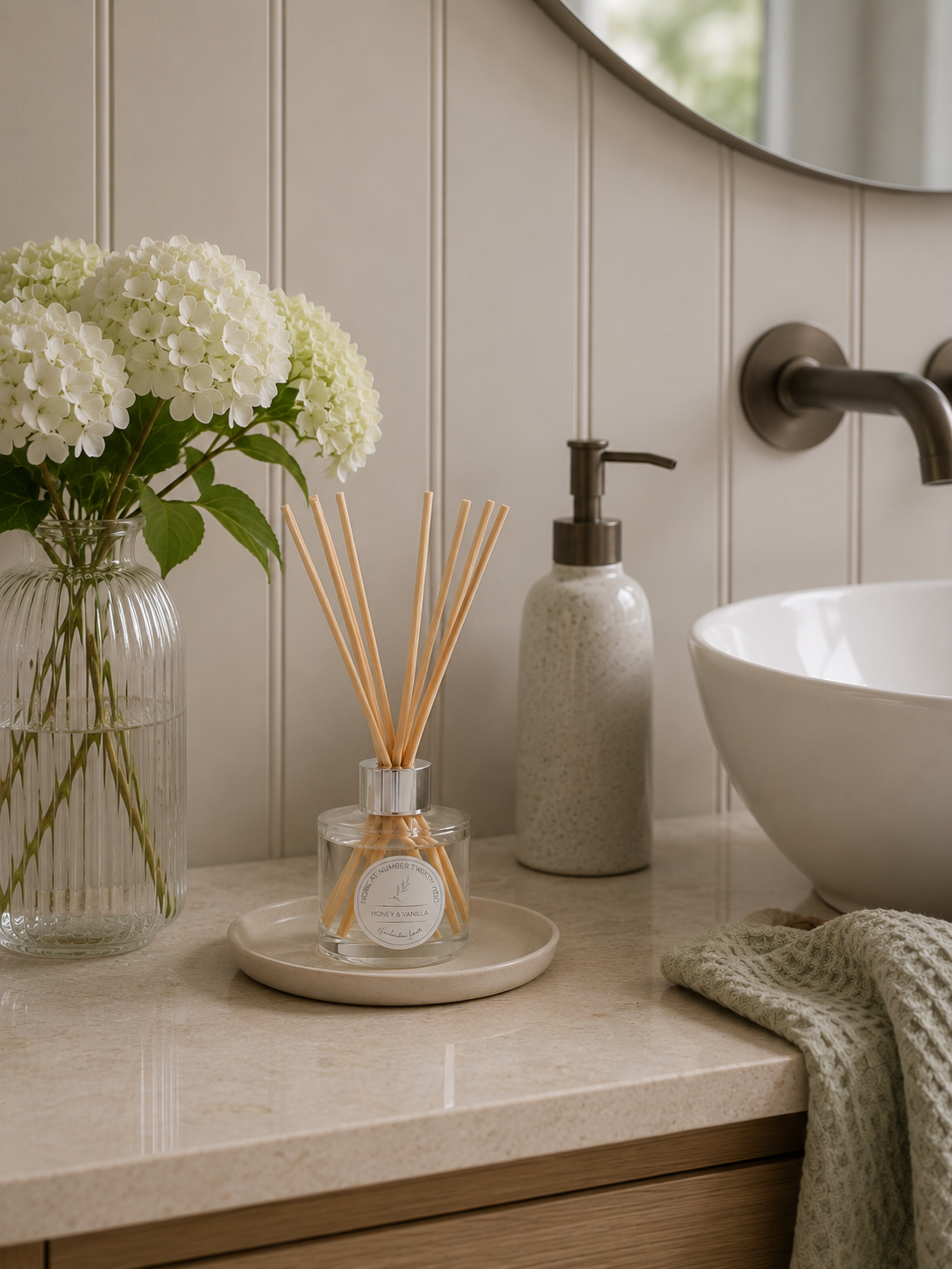 Honey & Vanilla Reed Diffuser styled in a modern bathroom, creating a warm spa-inspired atmosphere with soft honey and vanilla fragrance.