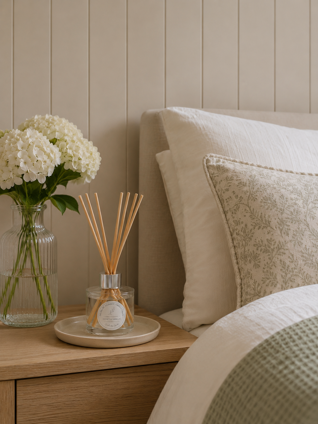Honey & Vanilla Reed Diffuser displayed on a bedside table in a cosy bedroom, adding warm and comforting home fragrance.