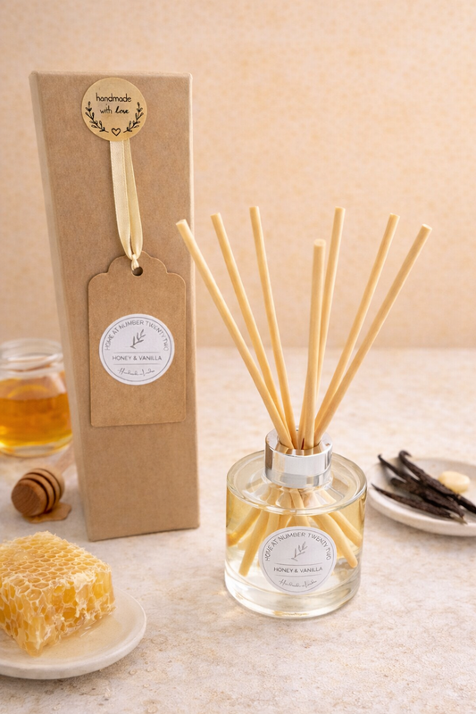 Honey and Vanilla Reed Diffuser with honeycomb and vanilla pods in setting
