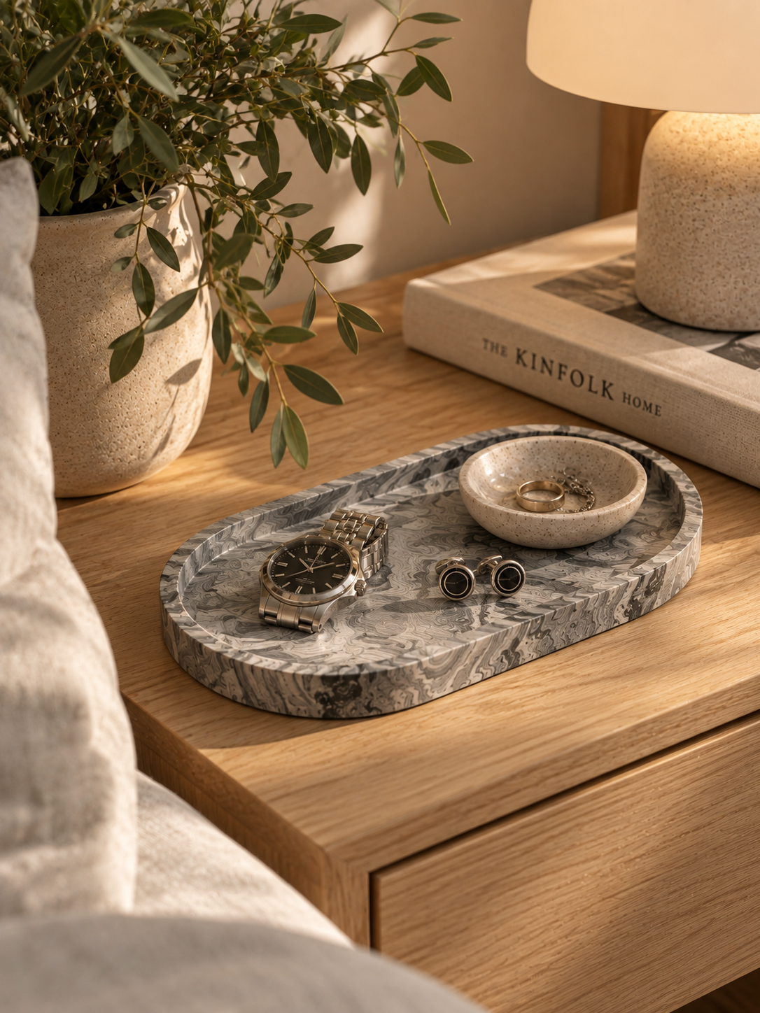 Marble-effect Jesmonite trinket tray with watch, cufflinks and jewellery on a Scandi style bedside table