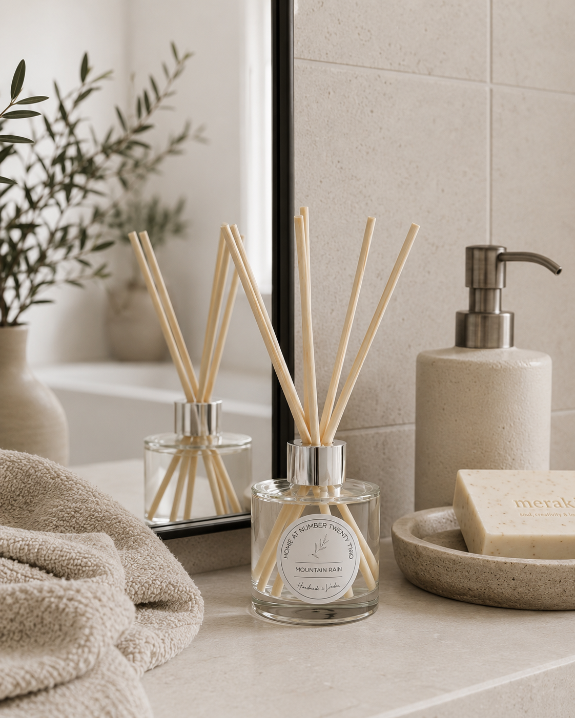 Luxury Mountain Rain Reed Diffuser displayed on a bathroom vanity with neutral accessories, bringing a fresh and calming home fragrance.