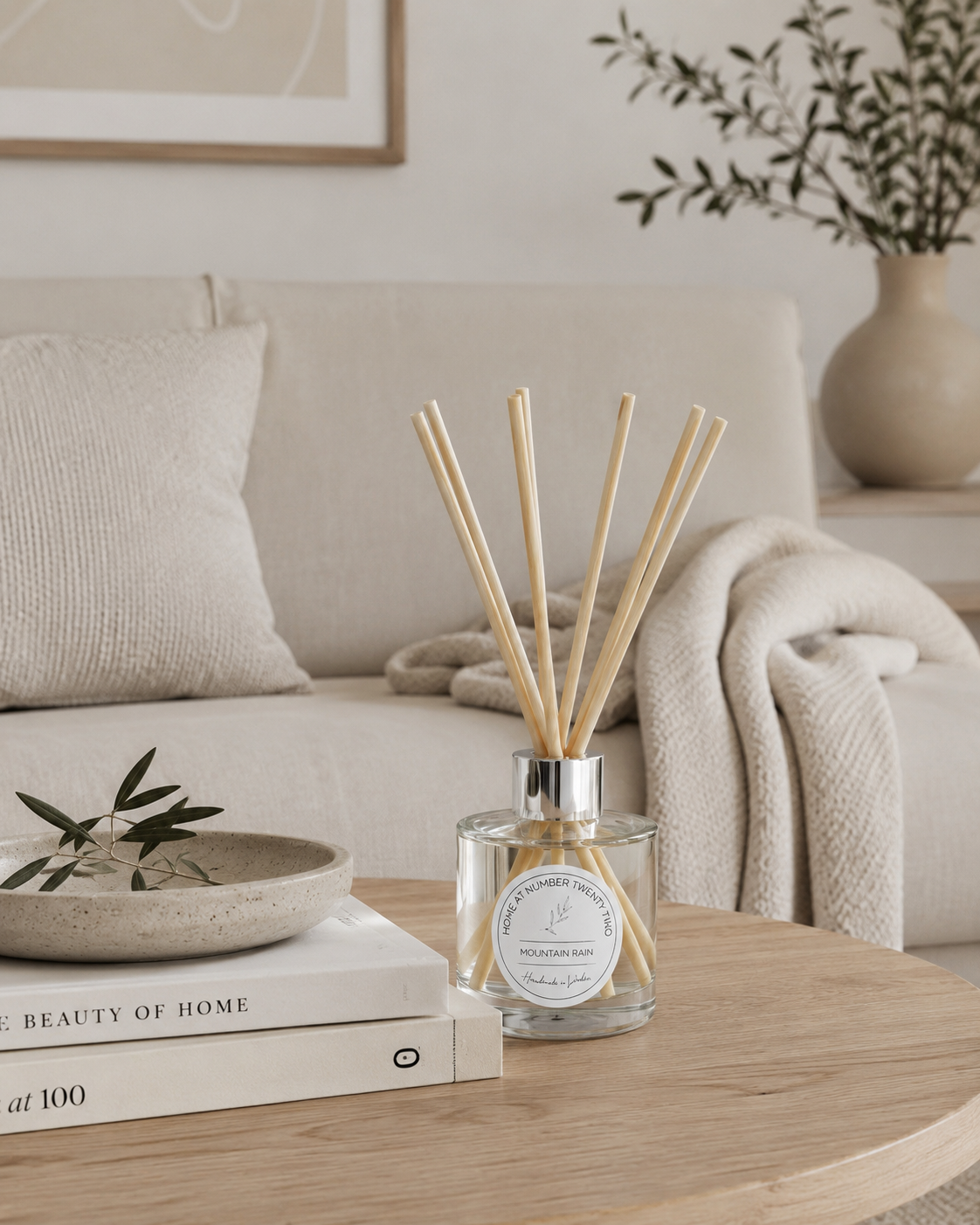Handmade Mountain Rain Reed Diffuser styled on a living room coffee table, creating a fresh and welcoming atmosphere in a modern home.