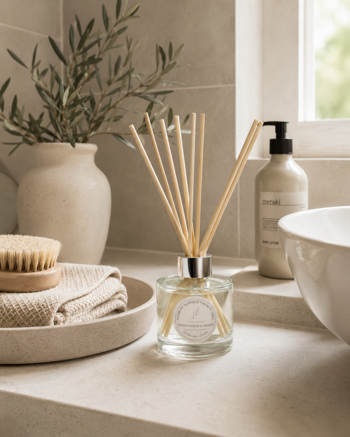 Luxury Sandalwood & Amber Reed Diffuser displayed in a contemporary bathroom, bringing a calming spa-inspired fragrance to your home.
