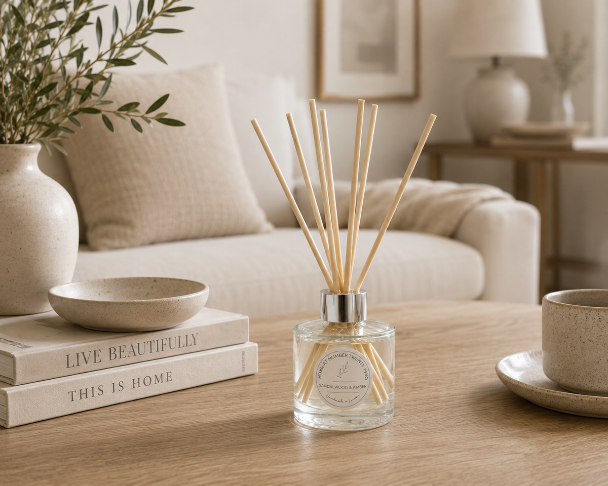 Sandalwood & Amber Reed Diffuser styled on a coffee table in a modern living room, creating a warm and luxurious home fragrance.