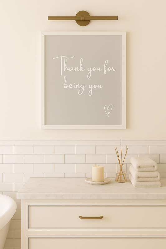 Bathroom with a framed print on the wall that says 'Thank you for being you' with a heart.