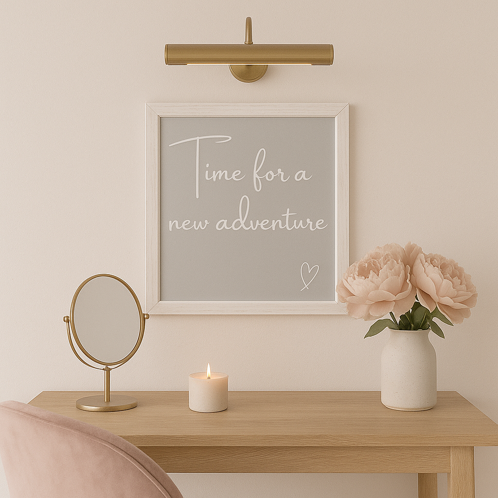 Decorative setup with a framed quote,''Time for a New Adventure'' mirror, candle, and vase on a wooden table.