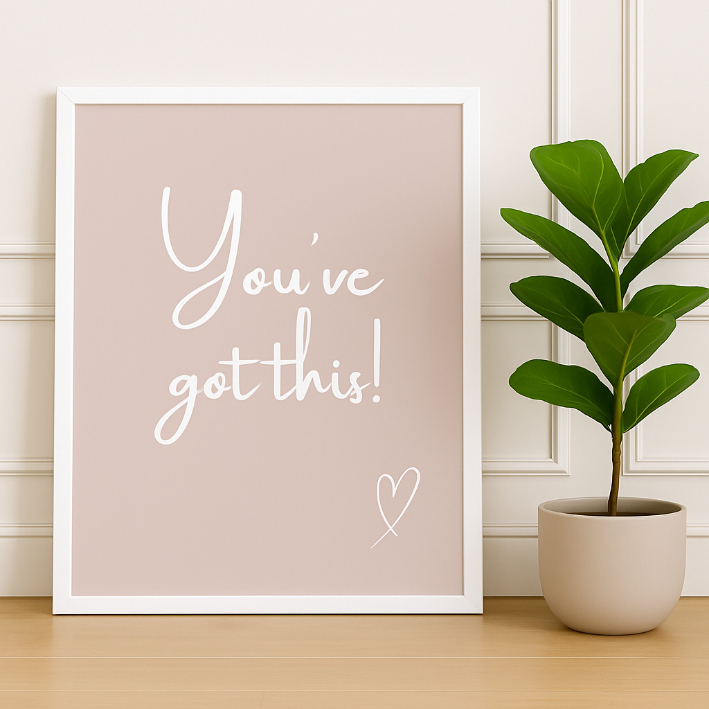 Framed motivational poster with 'You've got this!' text and a potted plant on a wooden surface.
