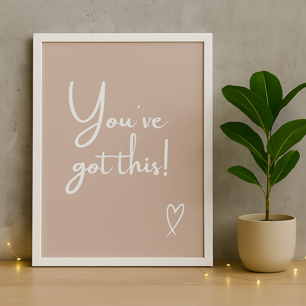 Framed motivational poster with 'You've got this!' text and a potted plant on a wooden surface.